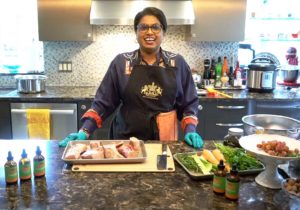 NHV's founder and president, Patra standing in her kitchen smiling with the ingredients for the beef bone broth