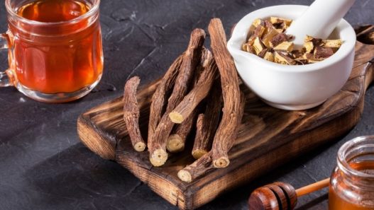 Dried licorice roots, licorice root pieces, and licorice tea all on a tabletop. Is licorice safe for pets?