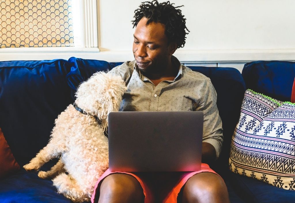 man with laptop and dog
