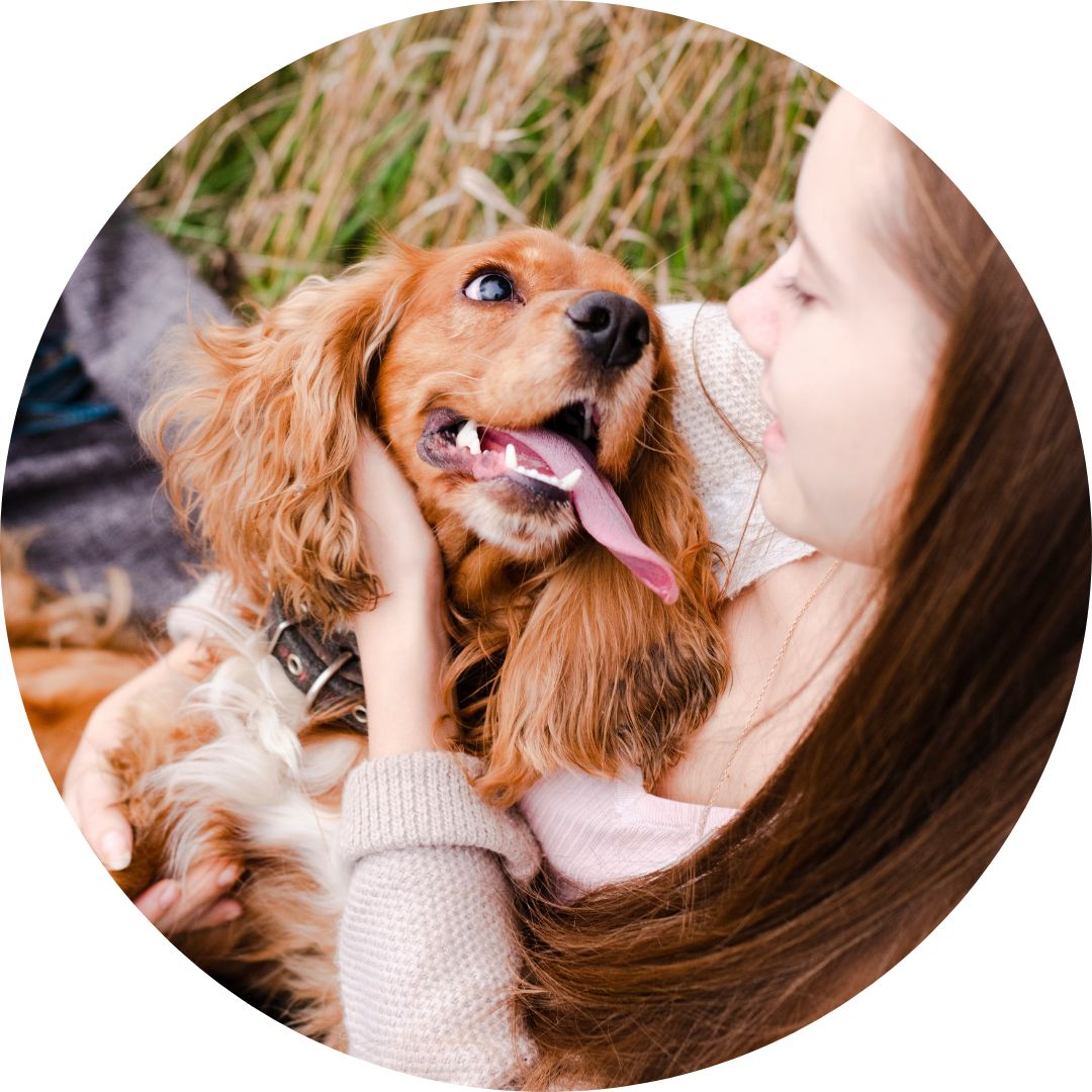 Photo of a girl hugging her dog with love for a blog illustrating the benefits Cod Liver Oil, Sardines and Anchovies for Dogs & Cats